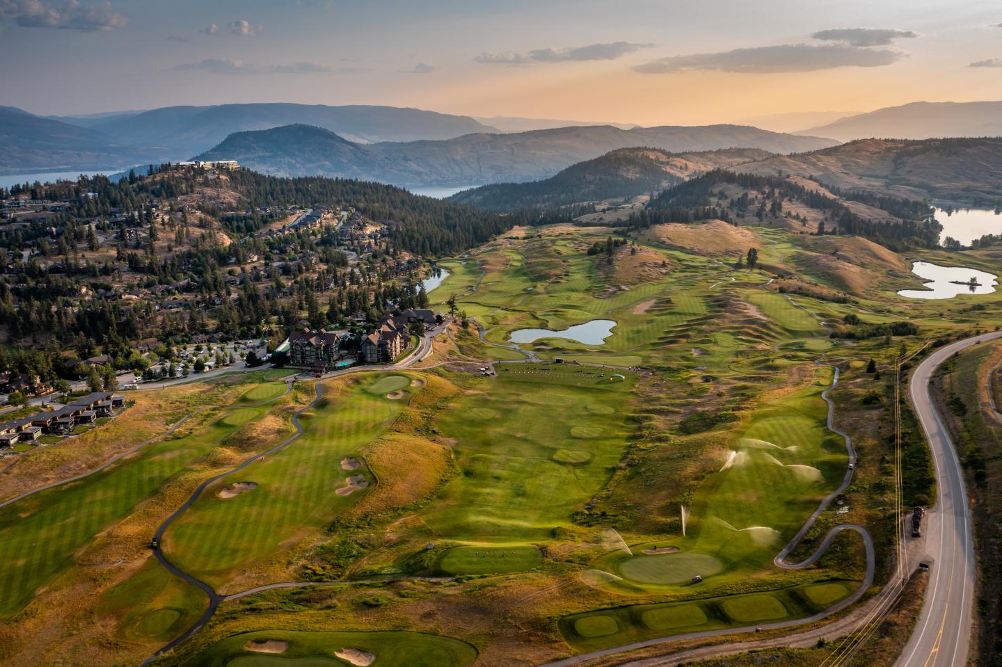 An aerial view of a golf course in the mountains