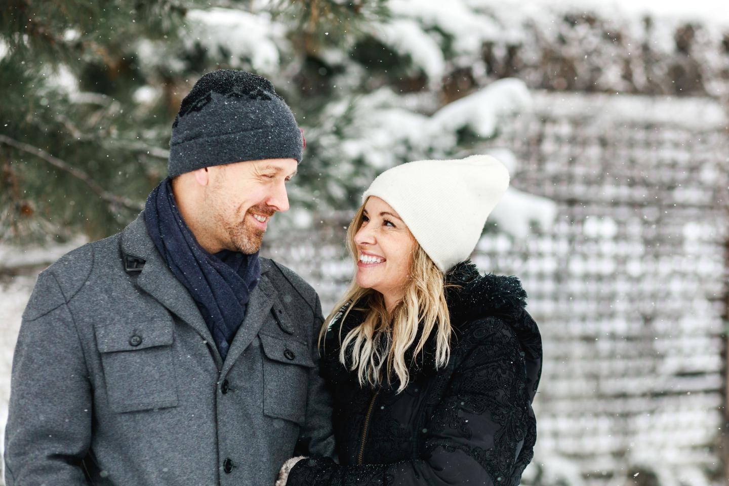 A couple smiling at each other in the snow