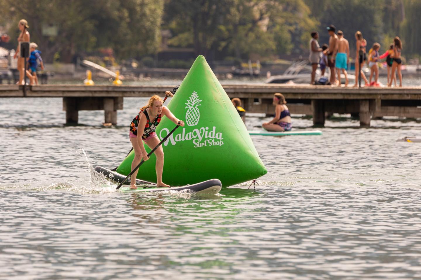 person doing paddleboard obstacle course