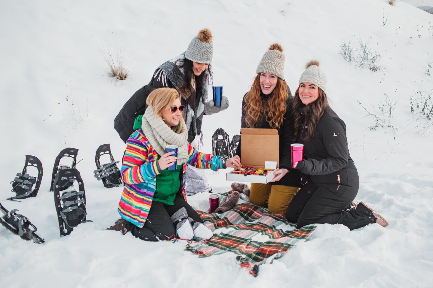 girls having snowy picnic