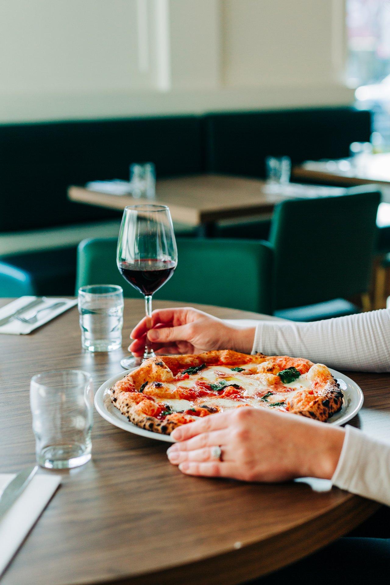 pizza and wine on a table at restaurant