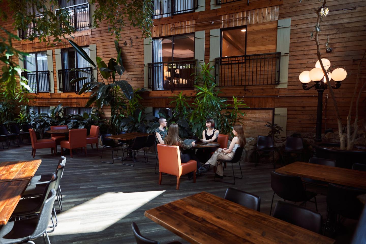 women sitting at table at atrium restaurant