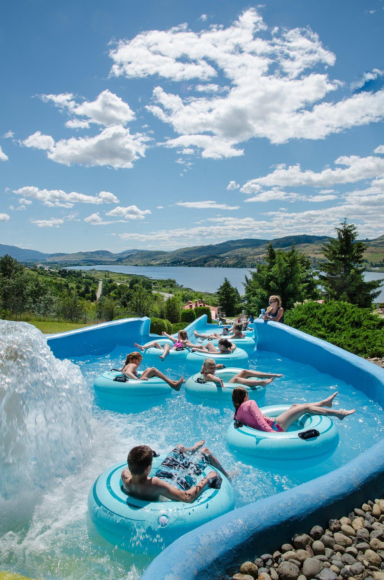 people on waterpark tubes lined up in tube river