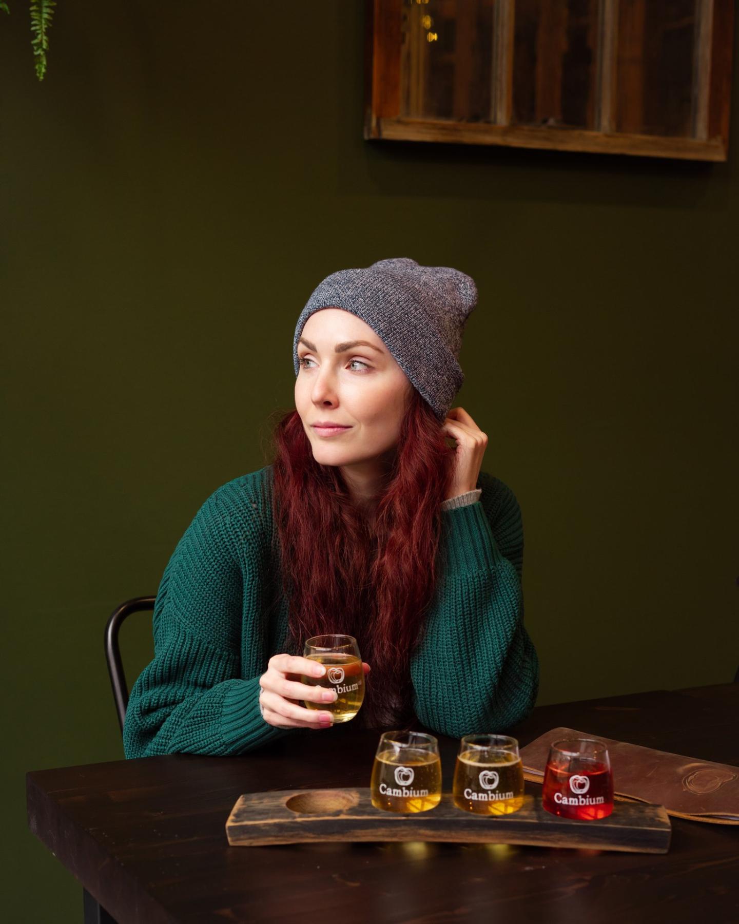 Woman with tasting flight at Cambium Cider Co