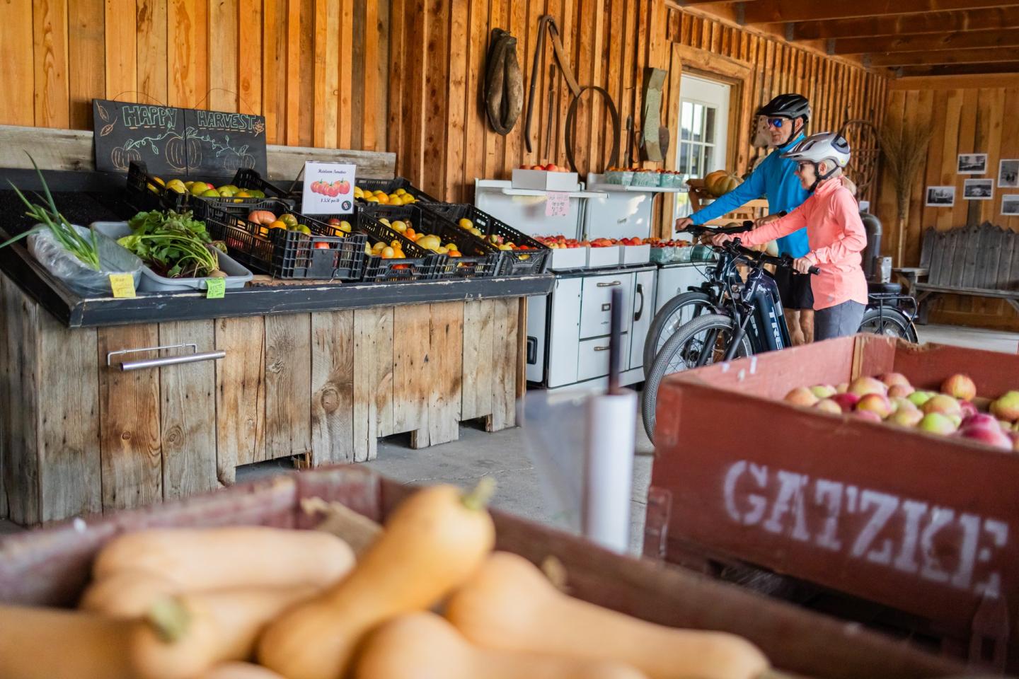couple with bikes at orchard fruit stand