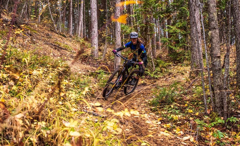 mountain biker going down trail