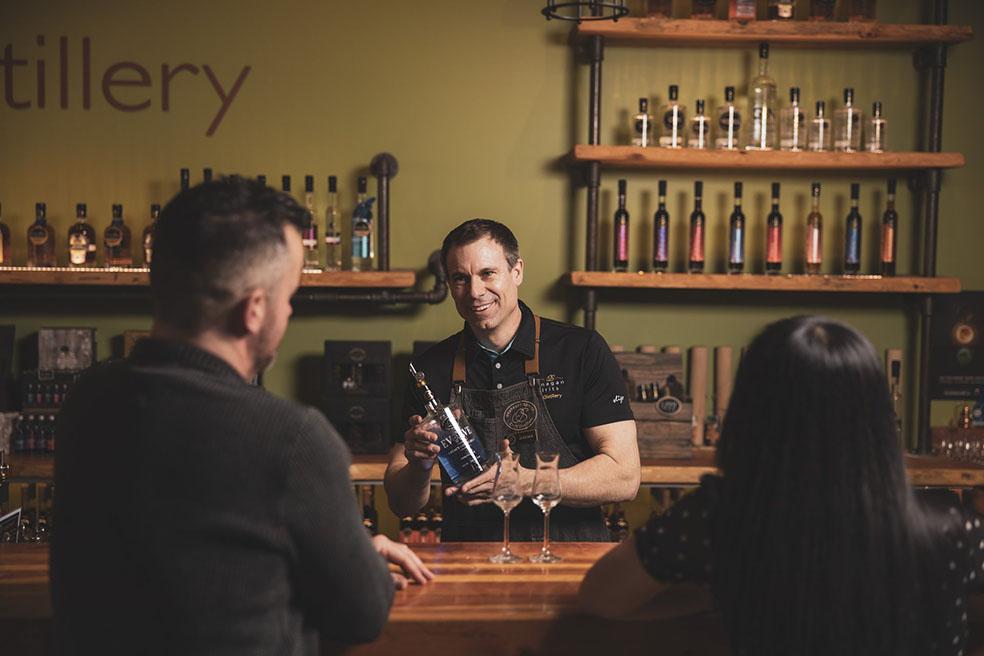bartender showing wine to customers
