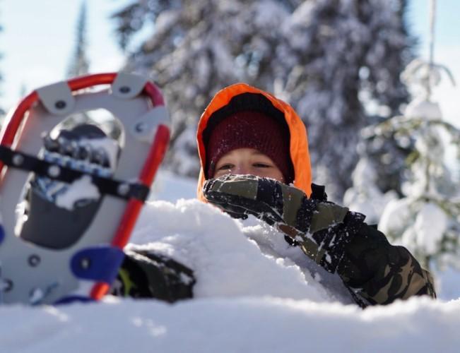 kid laying in snow