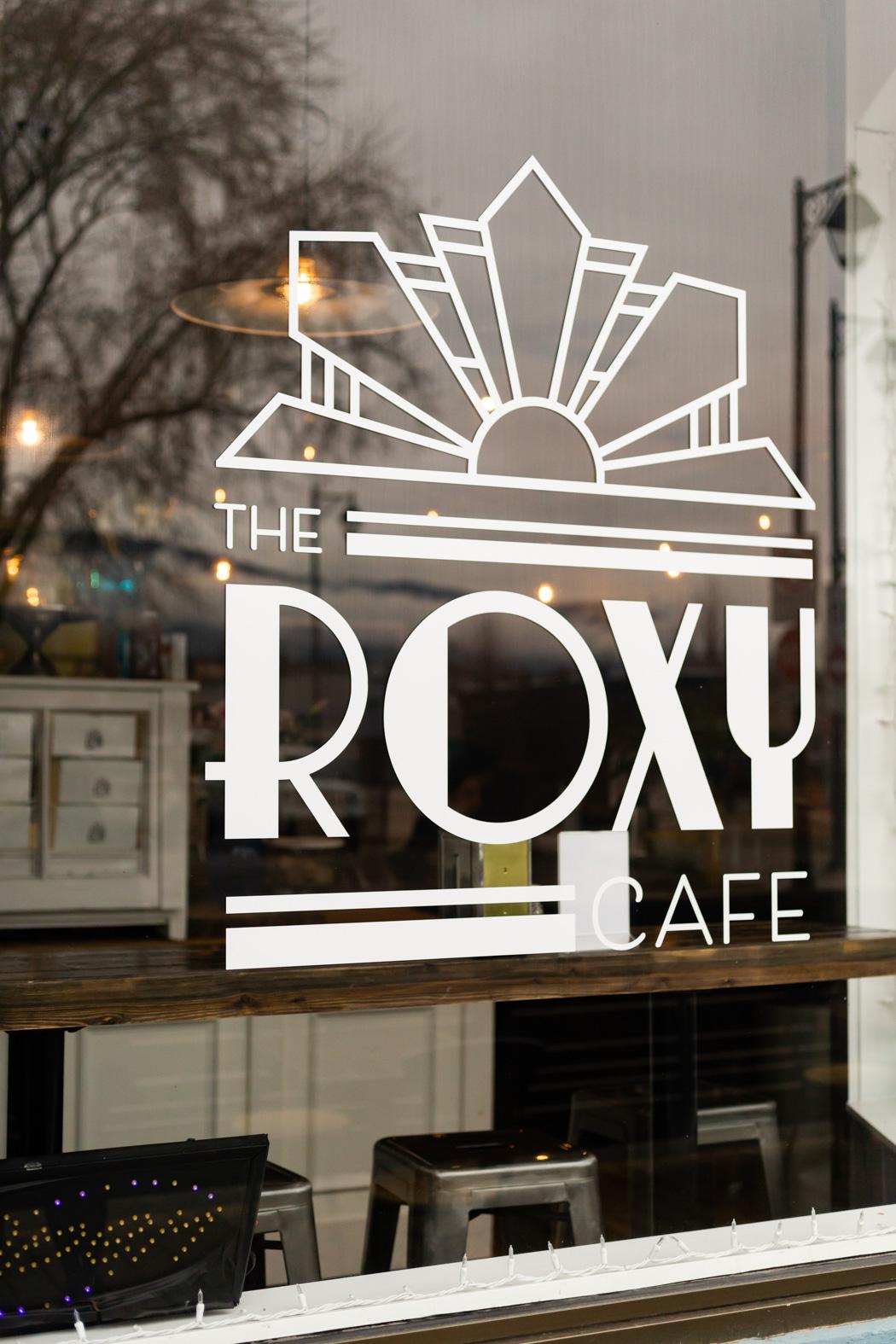 The Roxy Cafe sign on the window looking into the restaurant