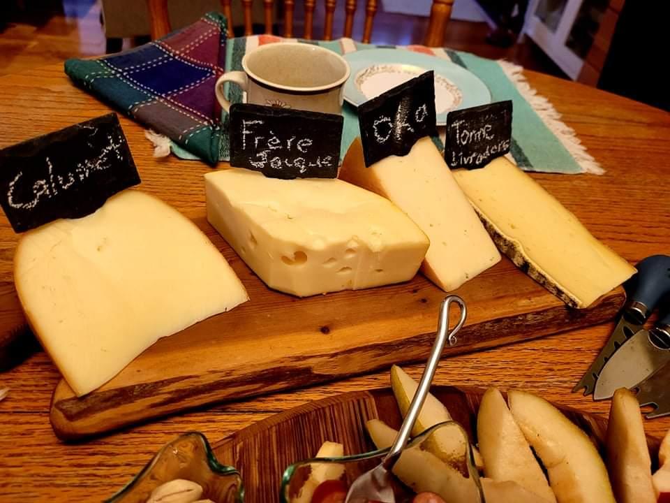 Array of cheese on a wooden board at Wedge Cheesery