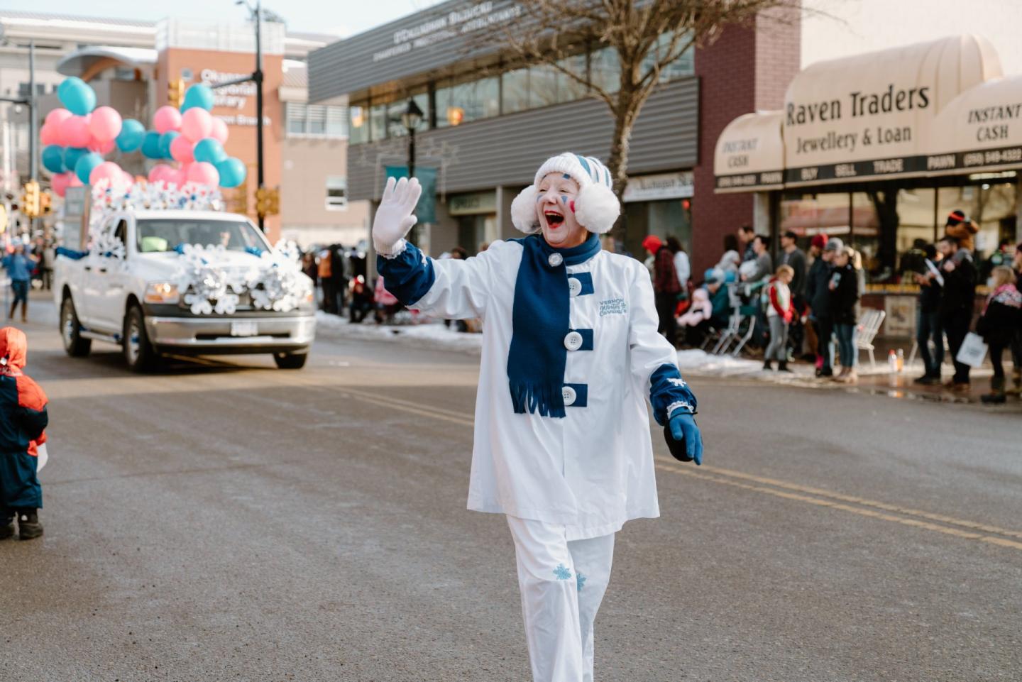 Parade going through downtown Vernon BC featuring a Jopette mascot
