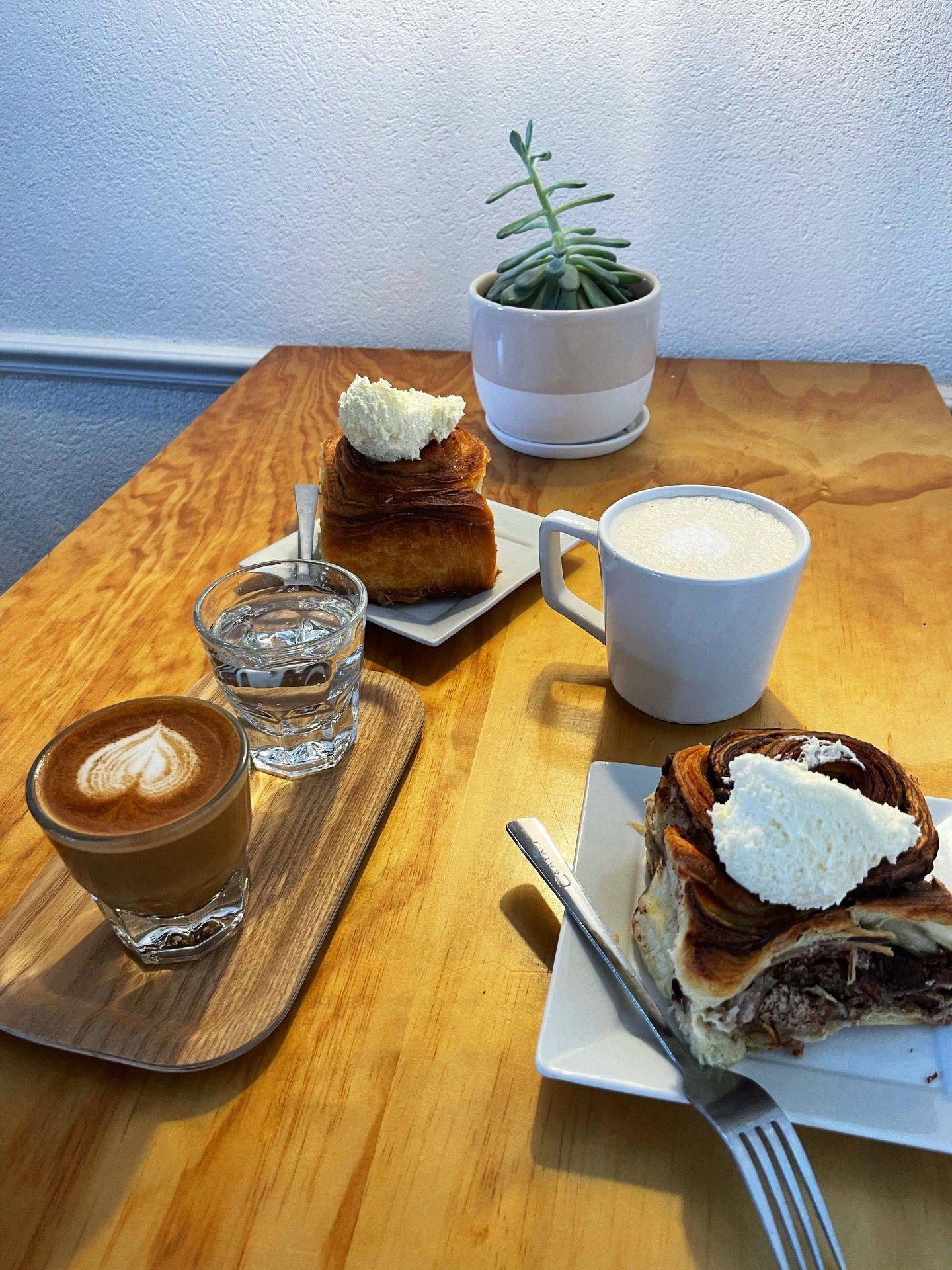 Coffee and pastries sitting on a table