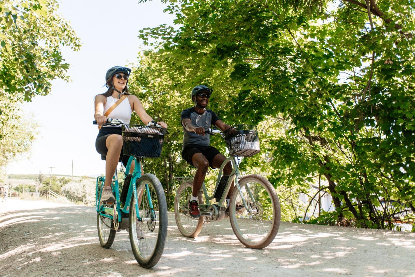 two people biking on multi-use pathway