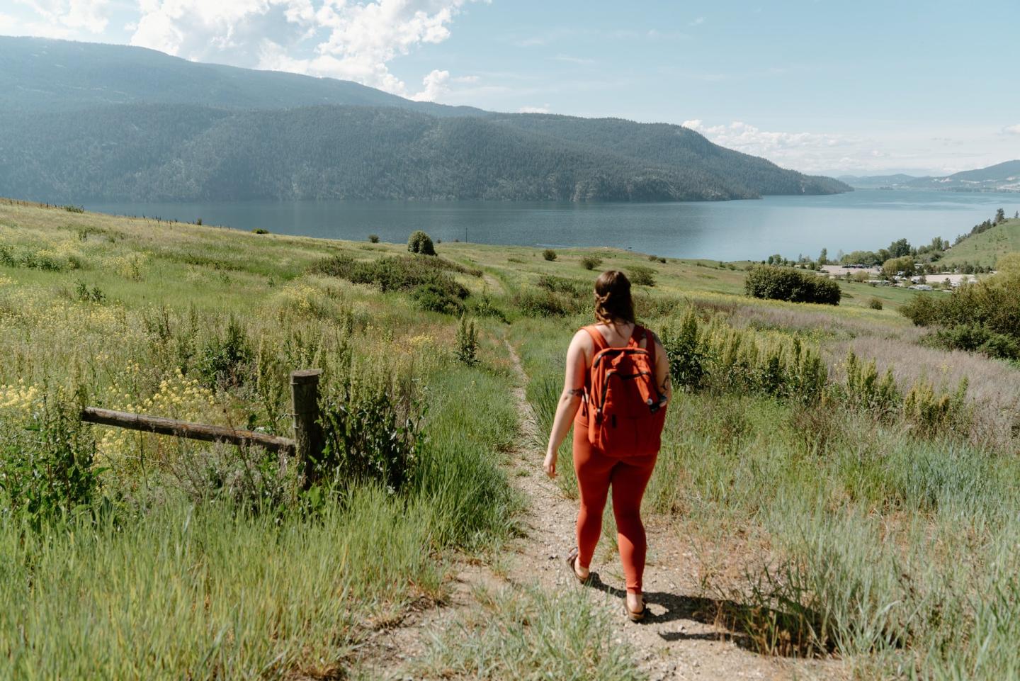 Woman hiking on a trail in Kalamalka Lake Park in Vernon