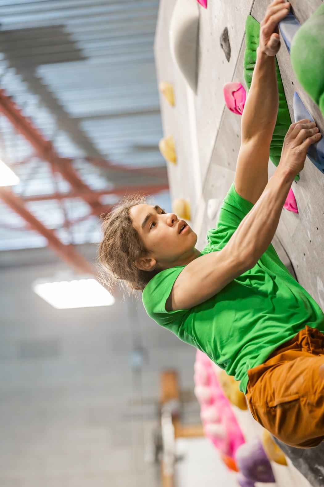 Teenager indoor rock cllimbing
