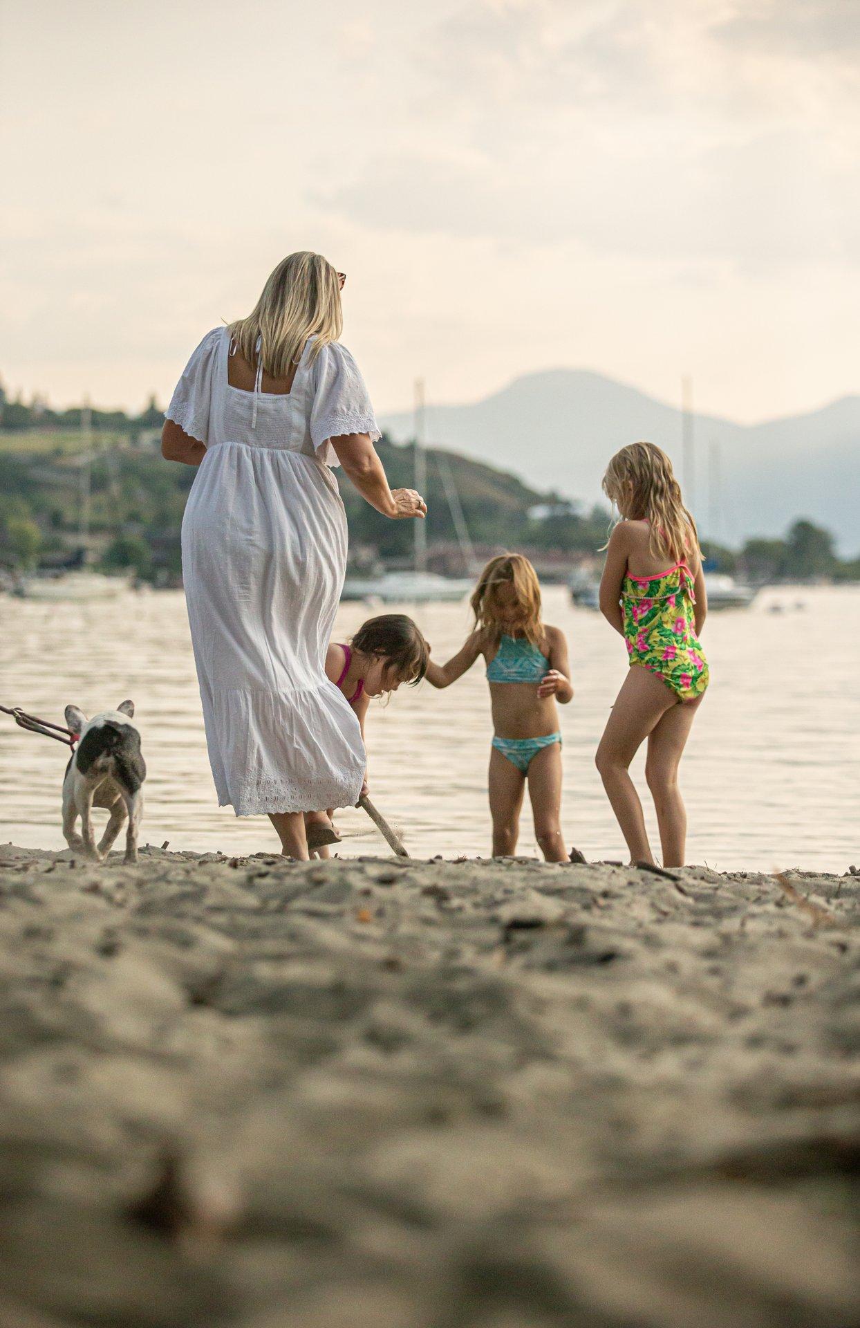 Woman, kids and dog at beach
