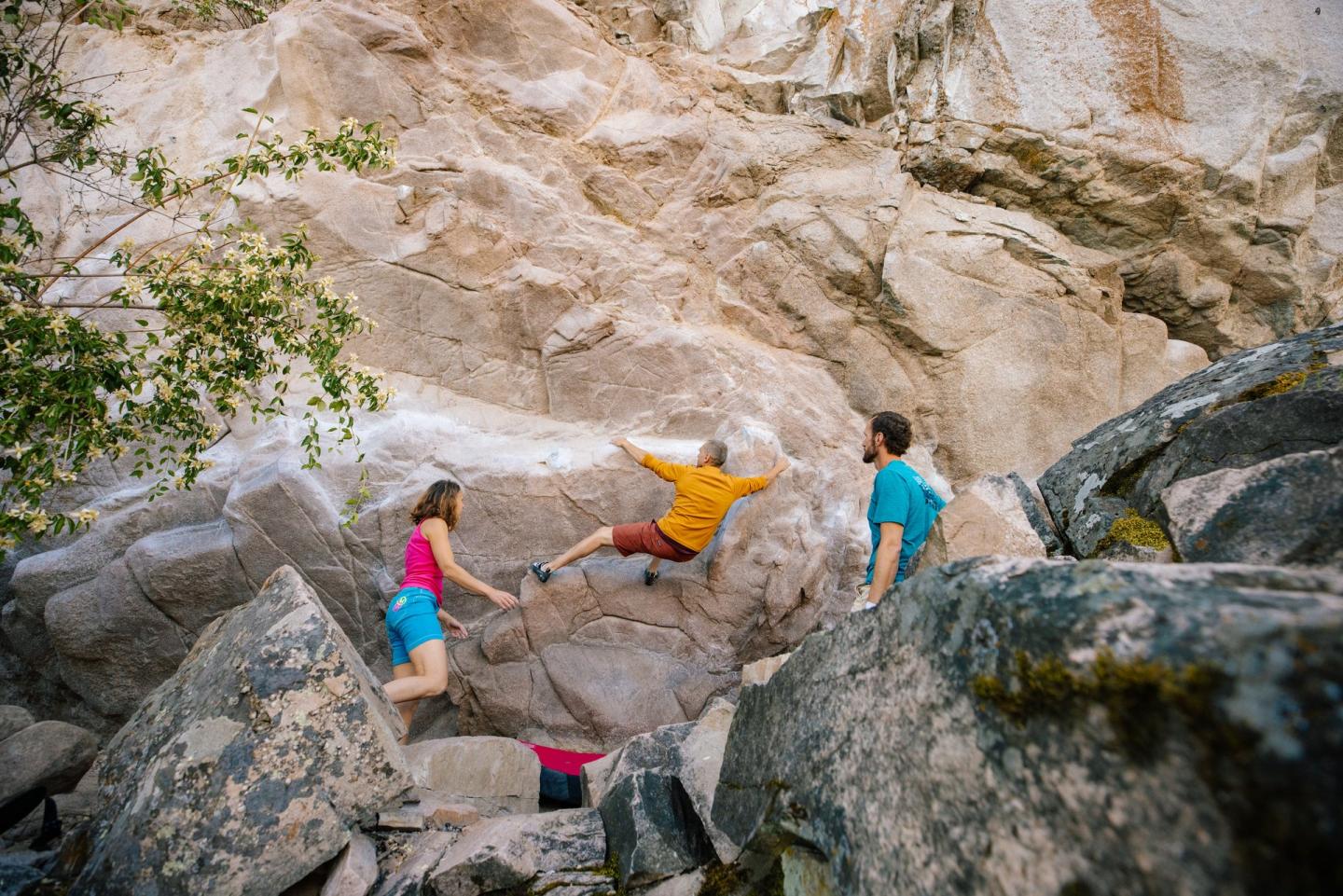 three friends bouldering together