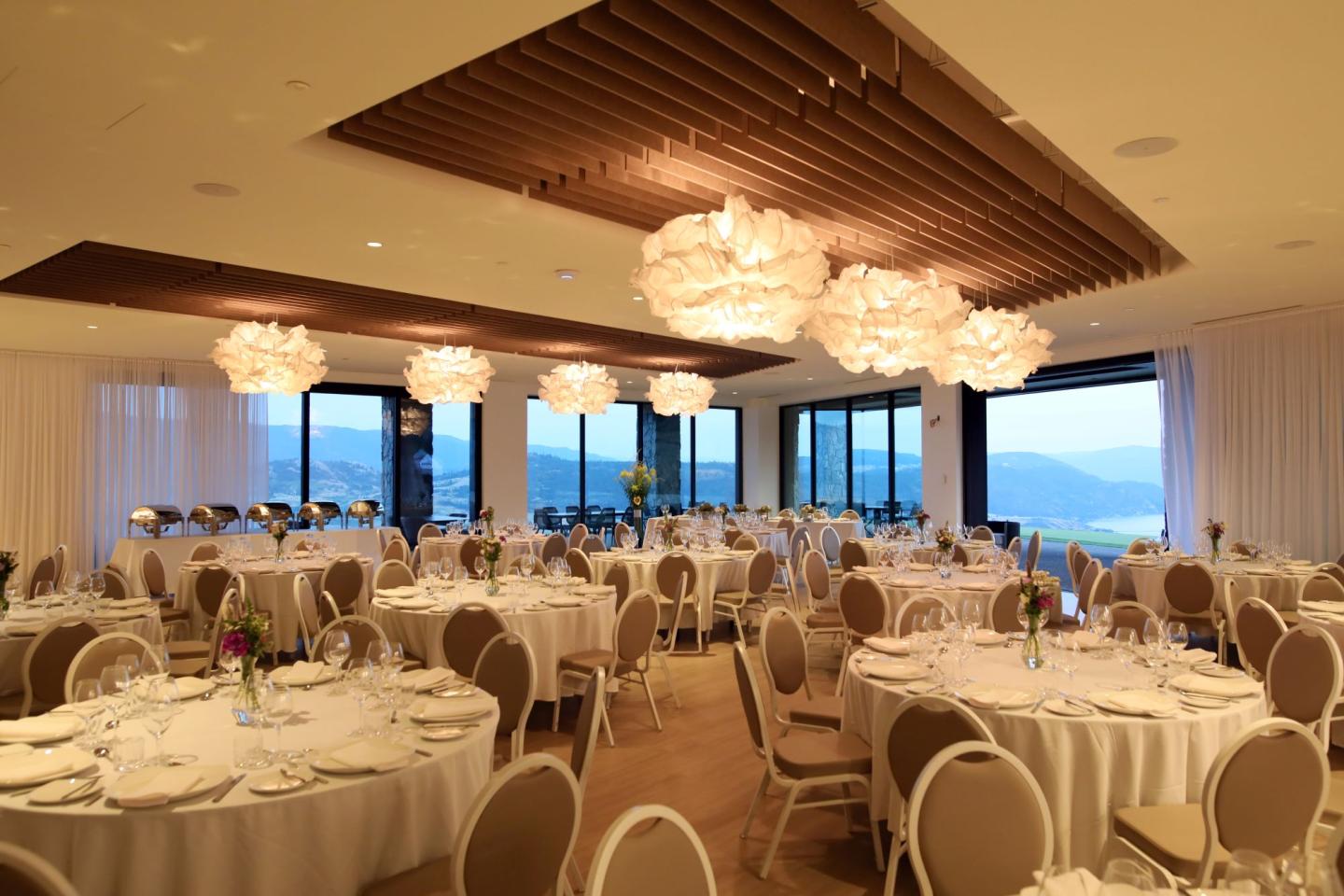 banquet room with large windows overlooking view of lake and golf course