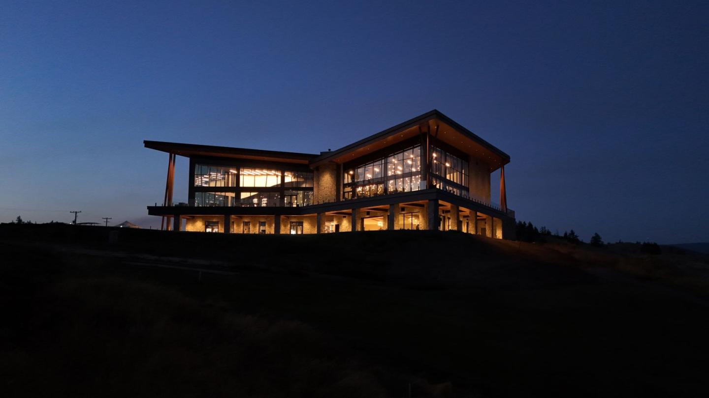Night view of large restaurant on top of a mountain lit up