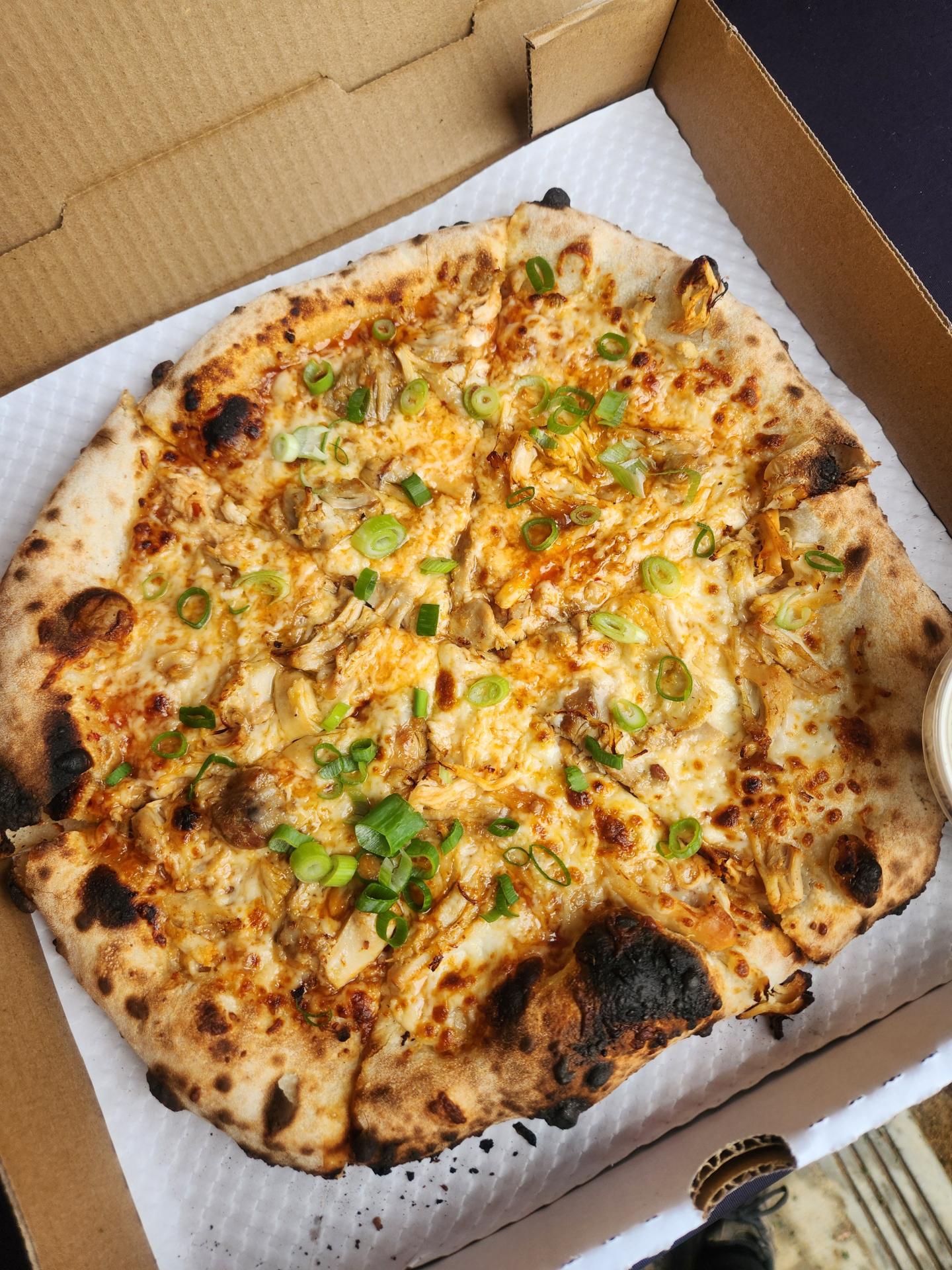 woodfire pizza in a pizza box
