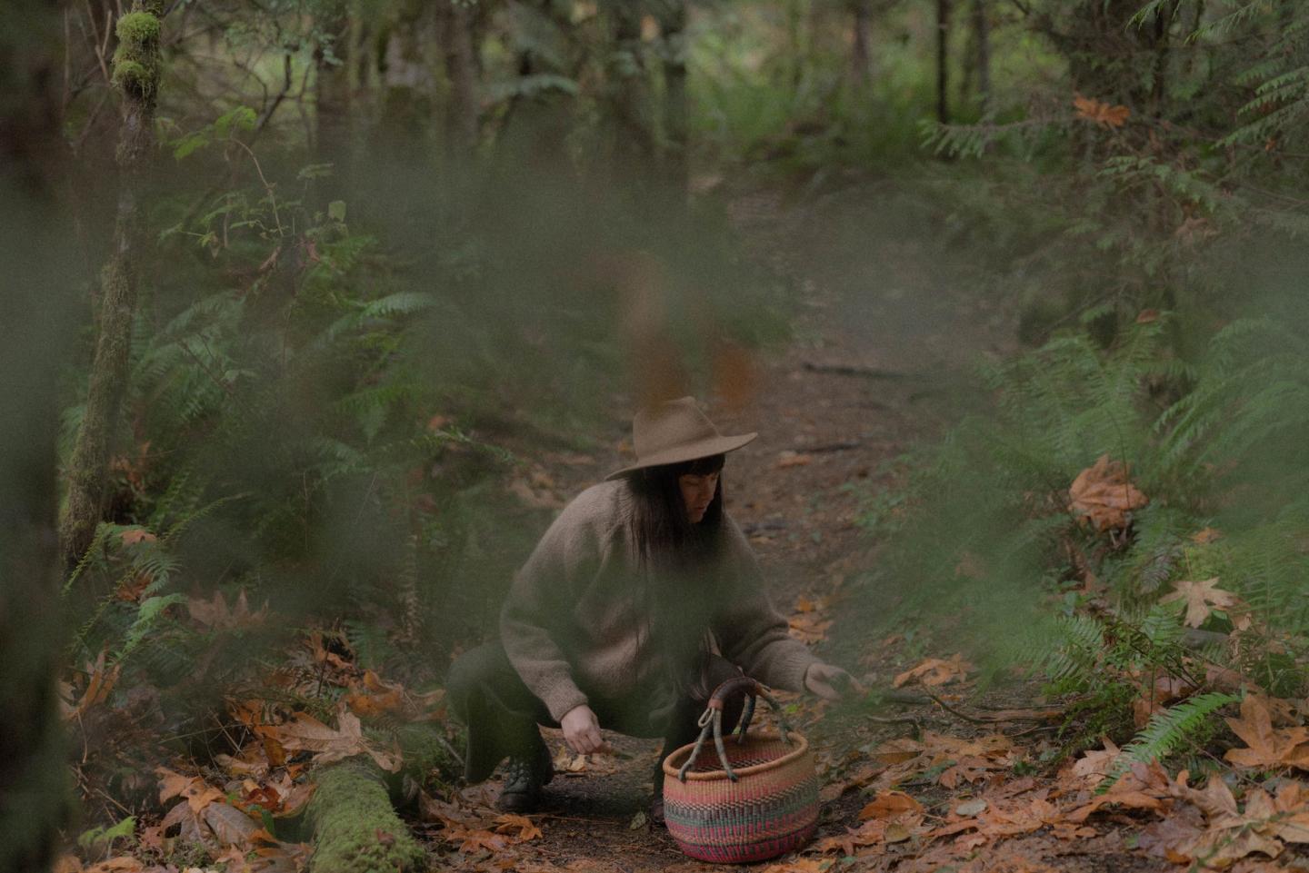 Woman picking mushrooms in the forest