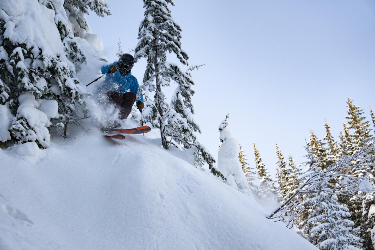 skier launching into fresh pow