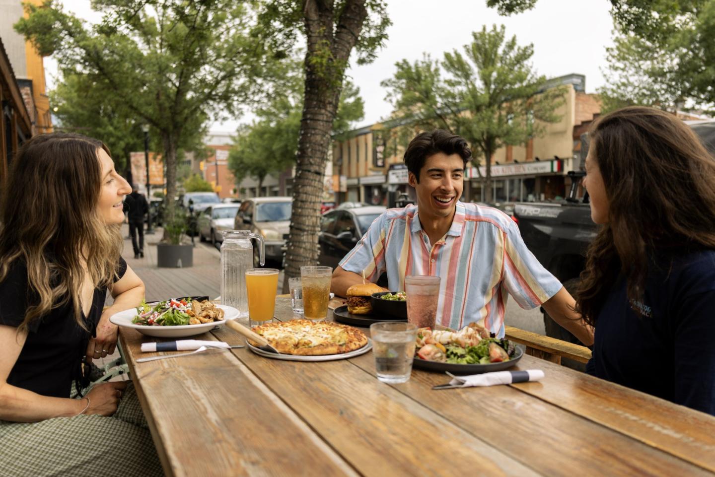 group of friends on a patio enjoying a craft beer