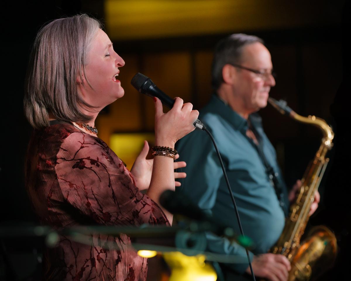 Woman singing and man on saxophone at the Vernon Jazz Club