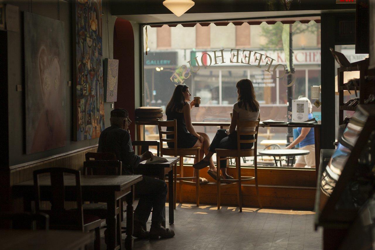 People drinking coffee in window