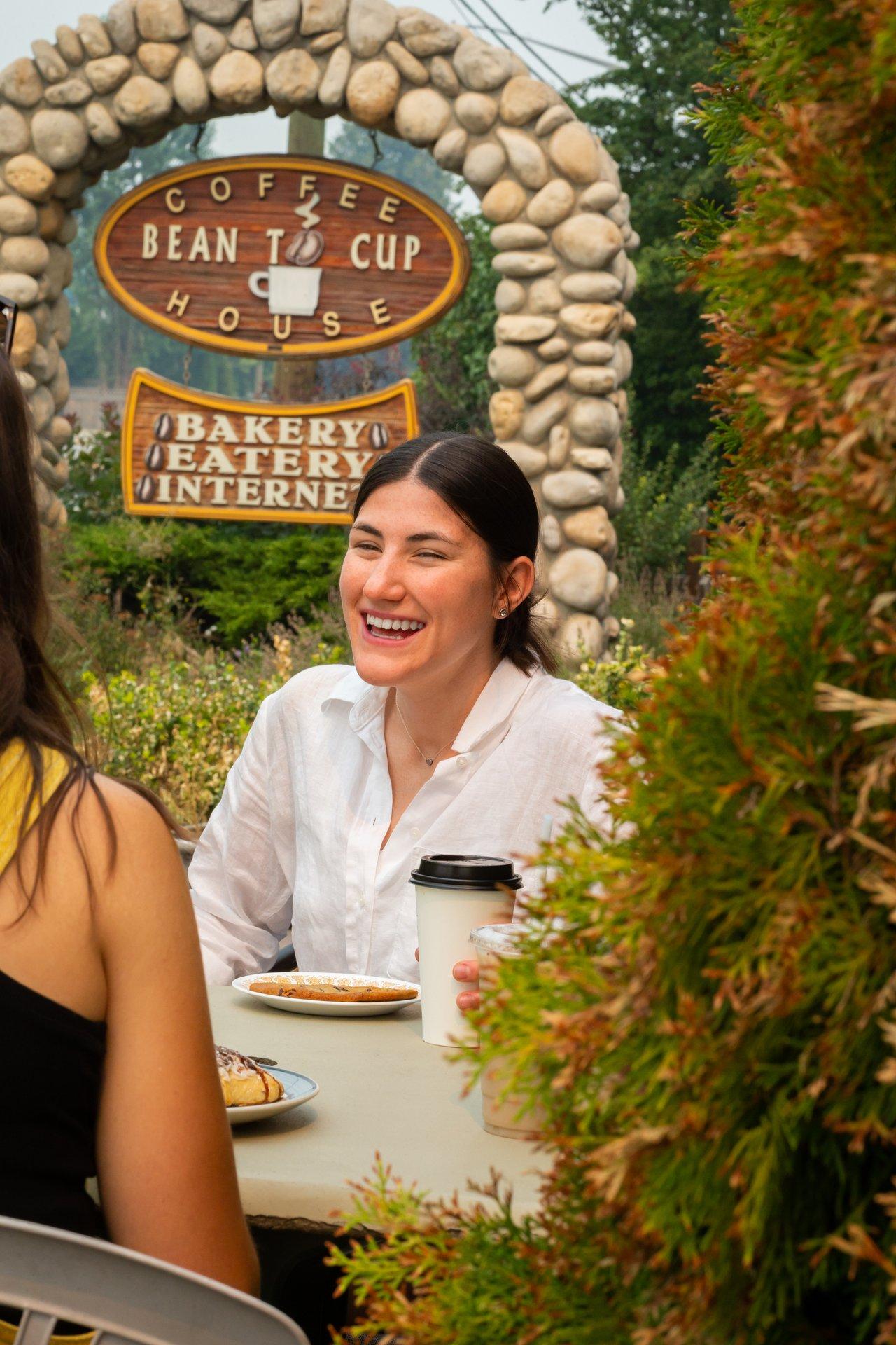 Lady laughing drinking coffee