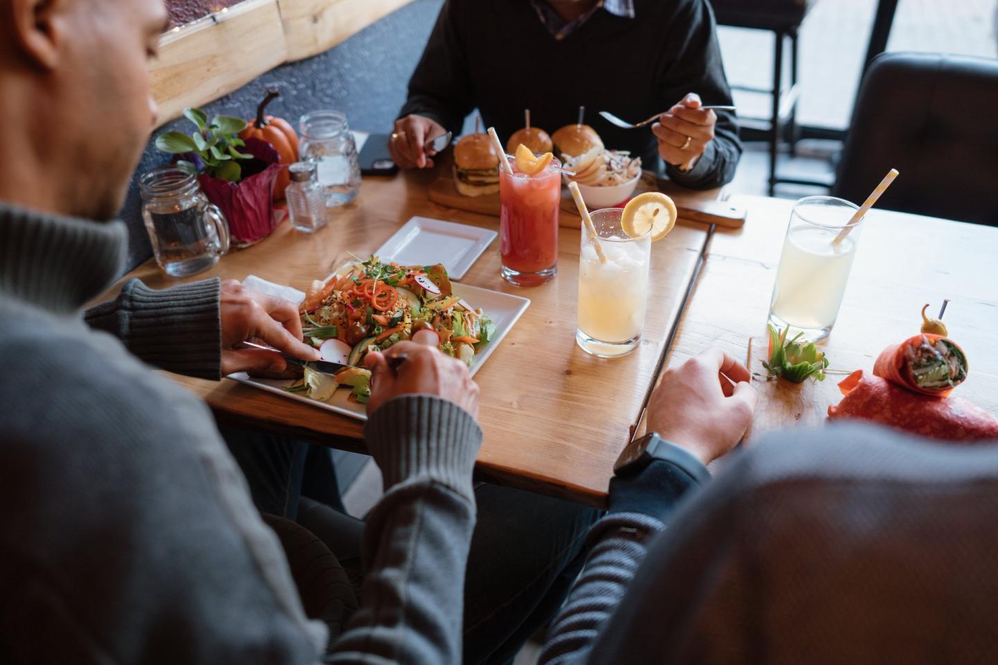 person eating a salad at a cafe