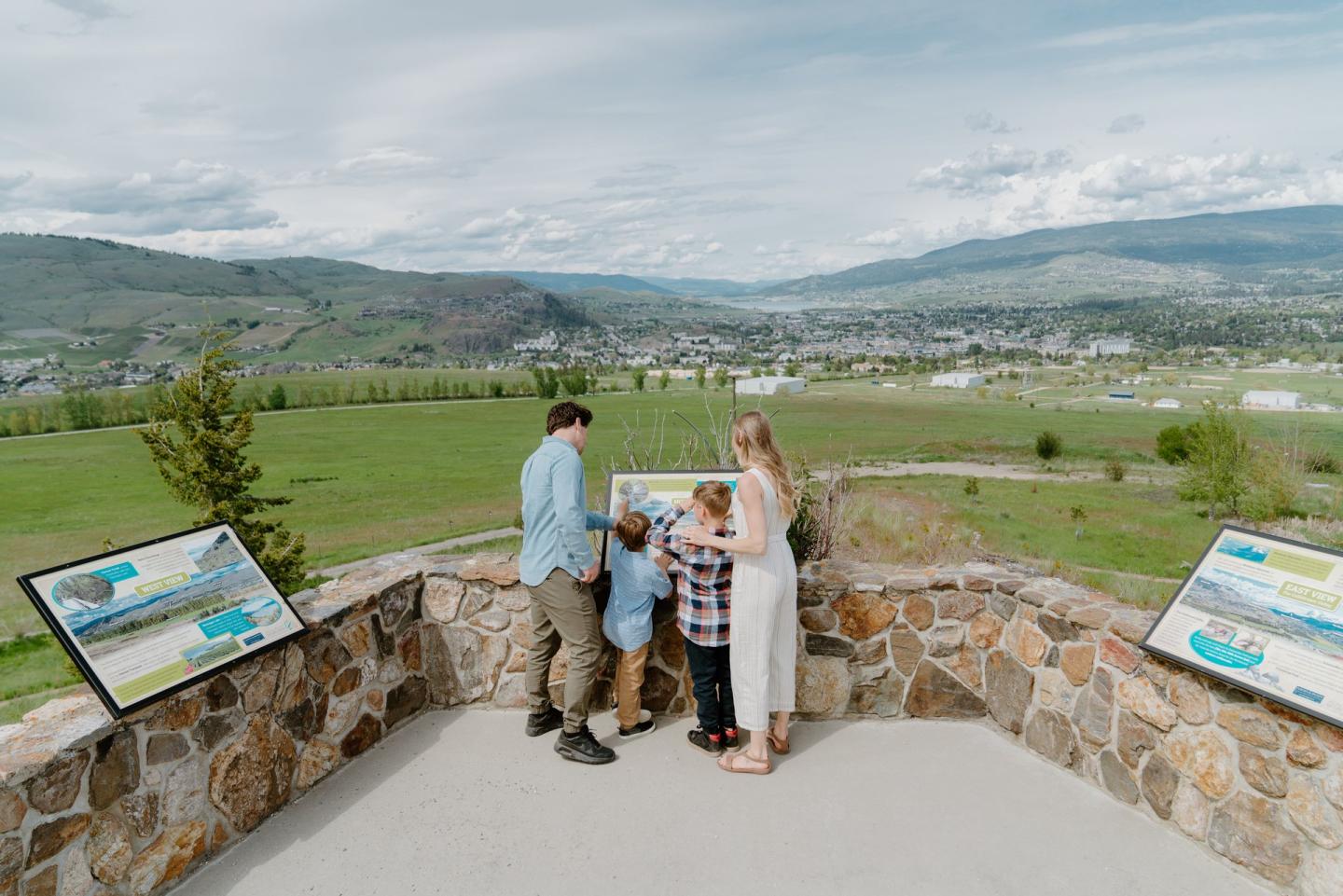 family looking at informational signage at a nature centre