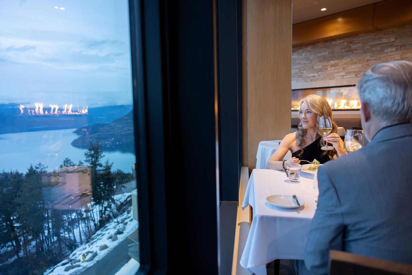 couple eating in fancy restaurant with lakeview out the window