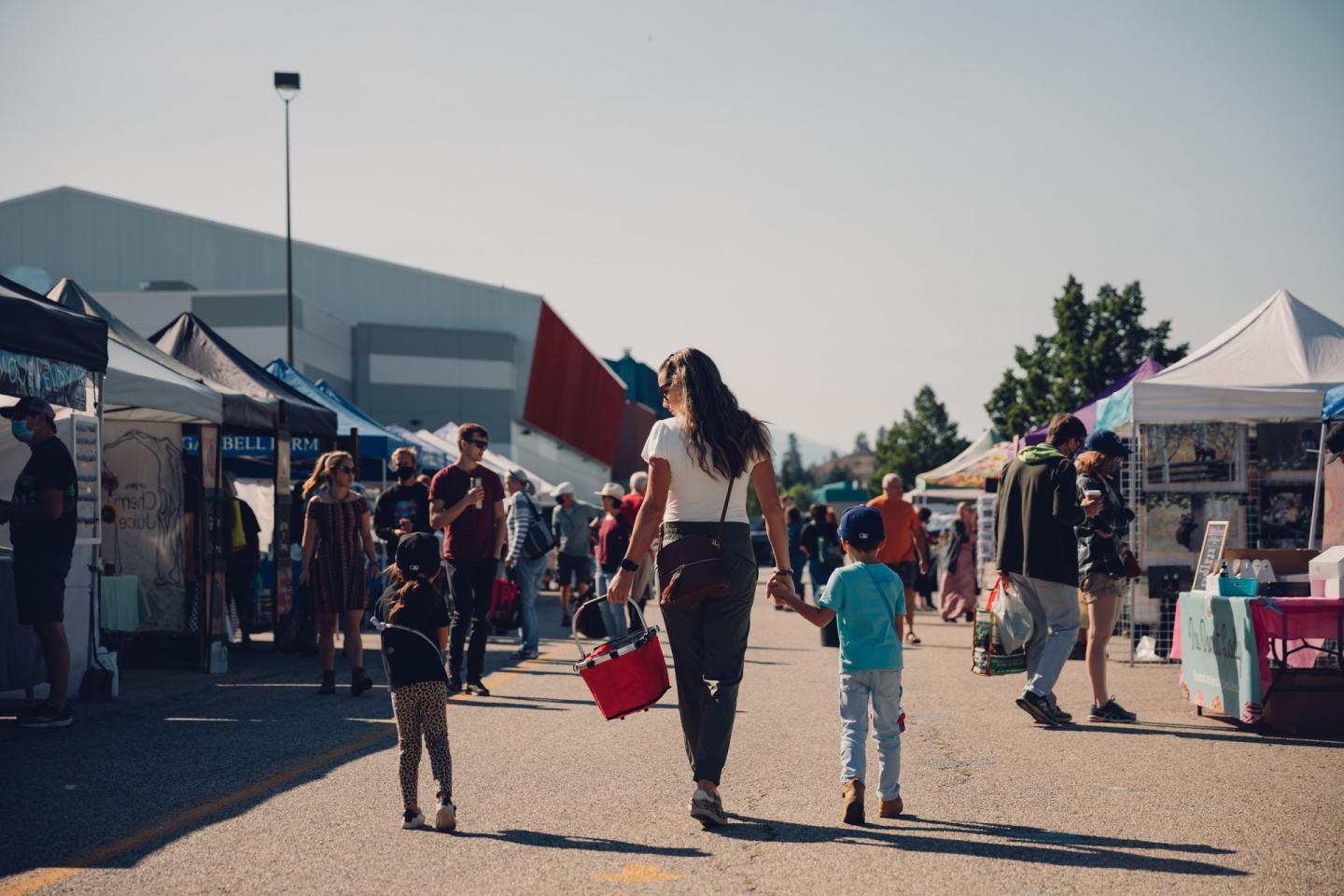 mother with two kids walking at farmers market