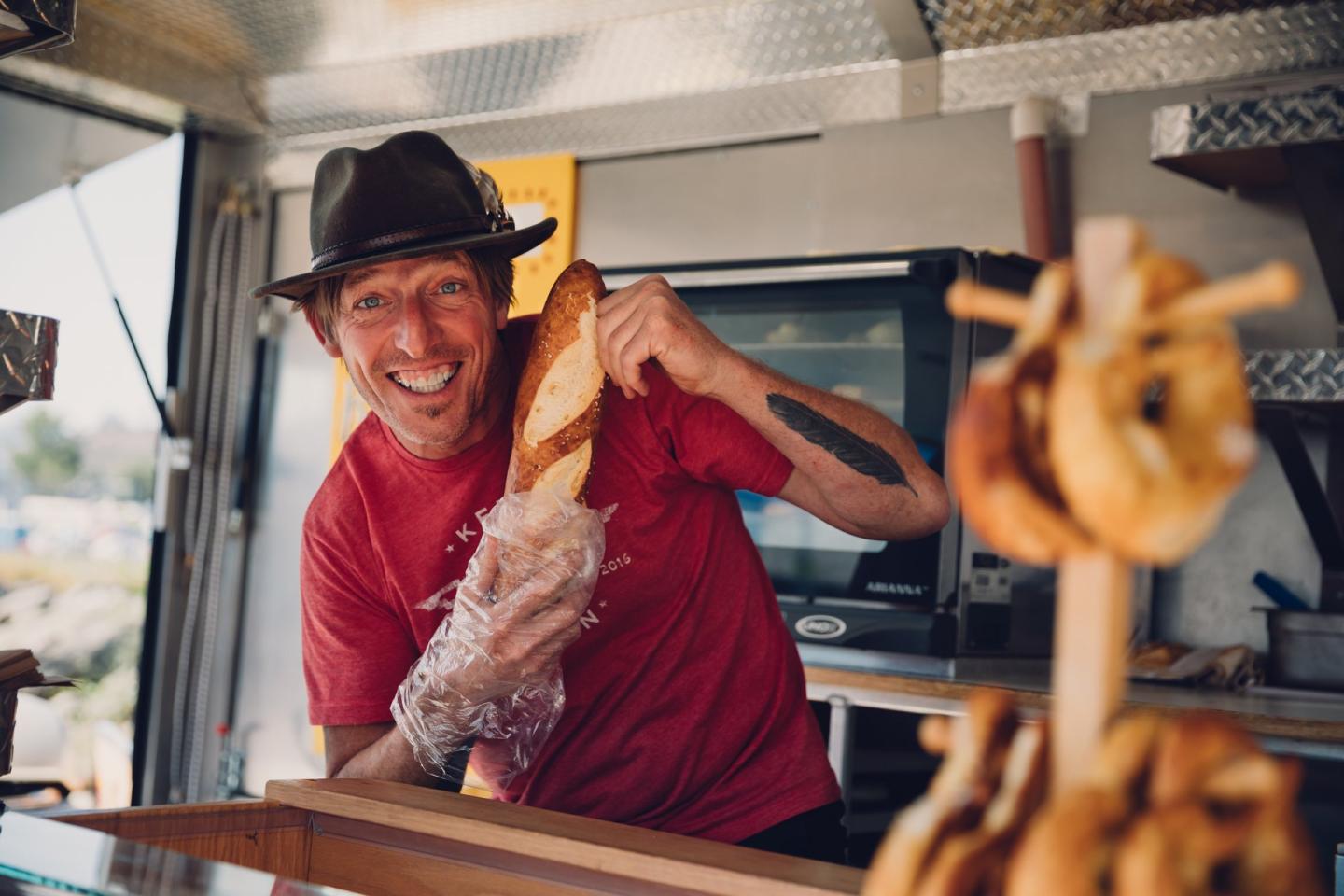 man with bread at farmers market stand