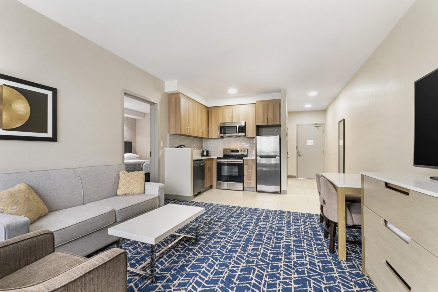 interior photo of a hotel room with full kitchen and lounge area