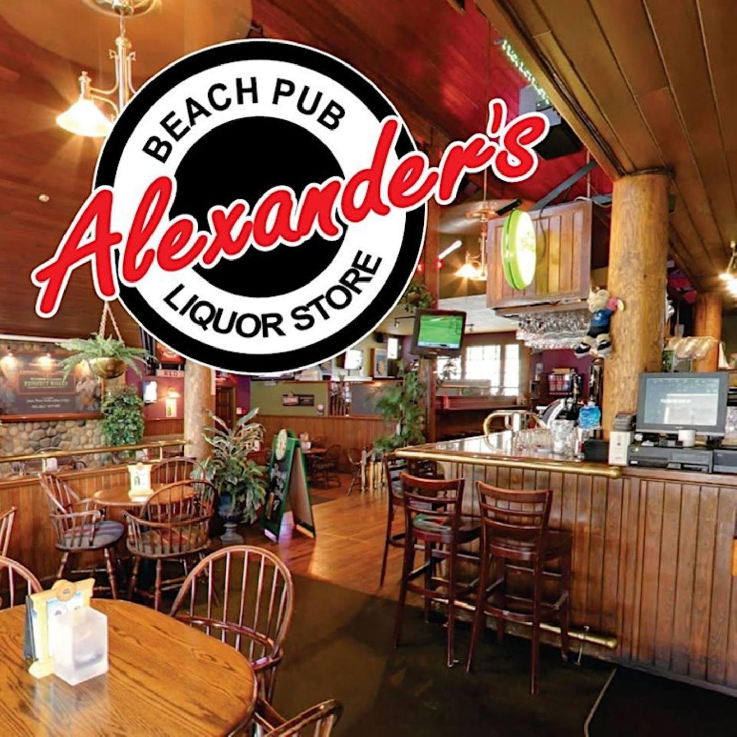 Pub interior with wooden tables and chairs, warm lighting, and a large logo.