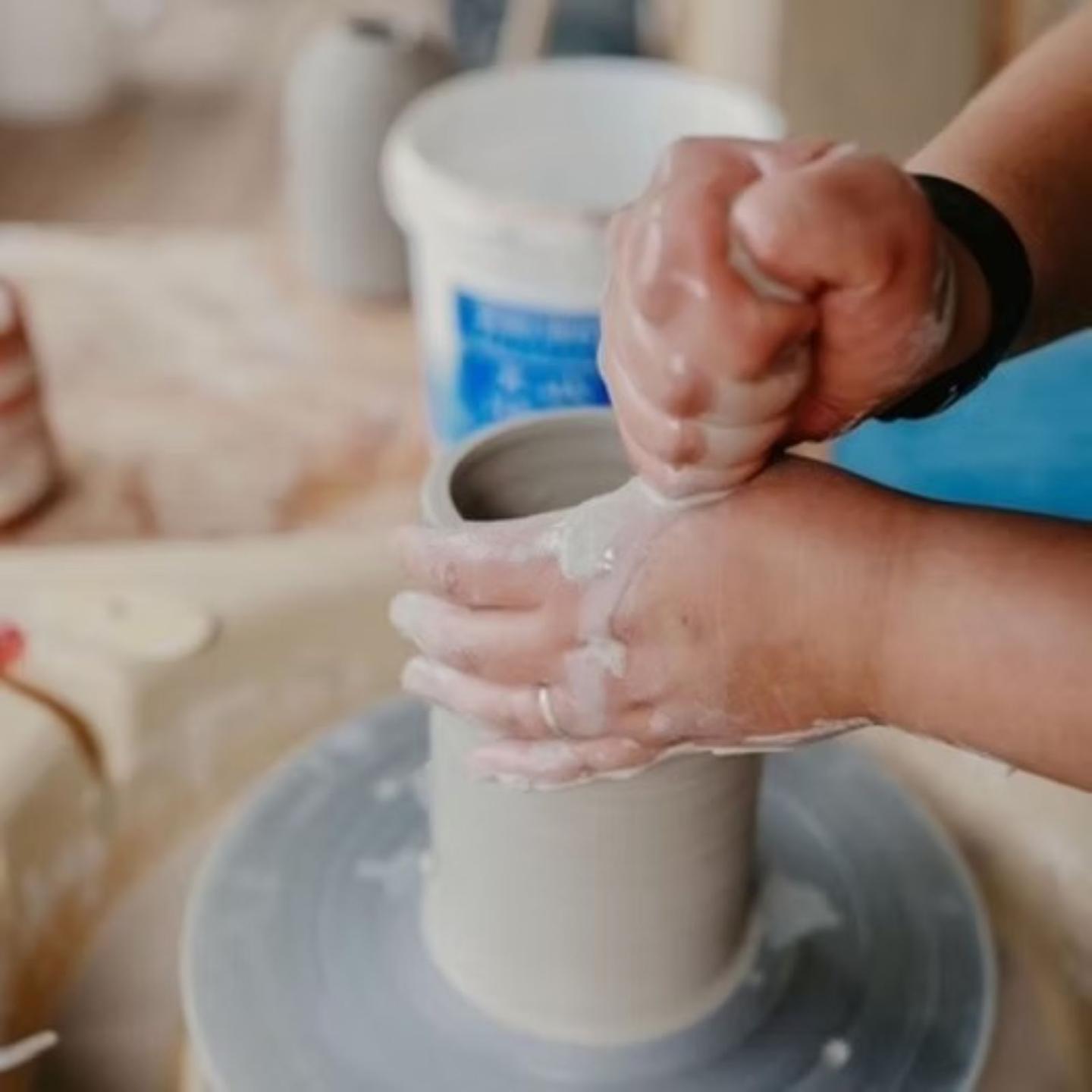 close up of clay vase on pottery wheel