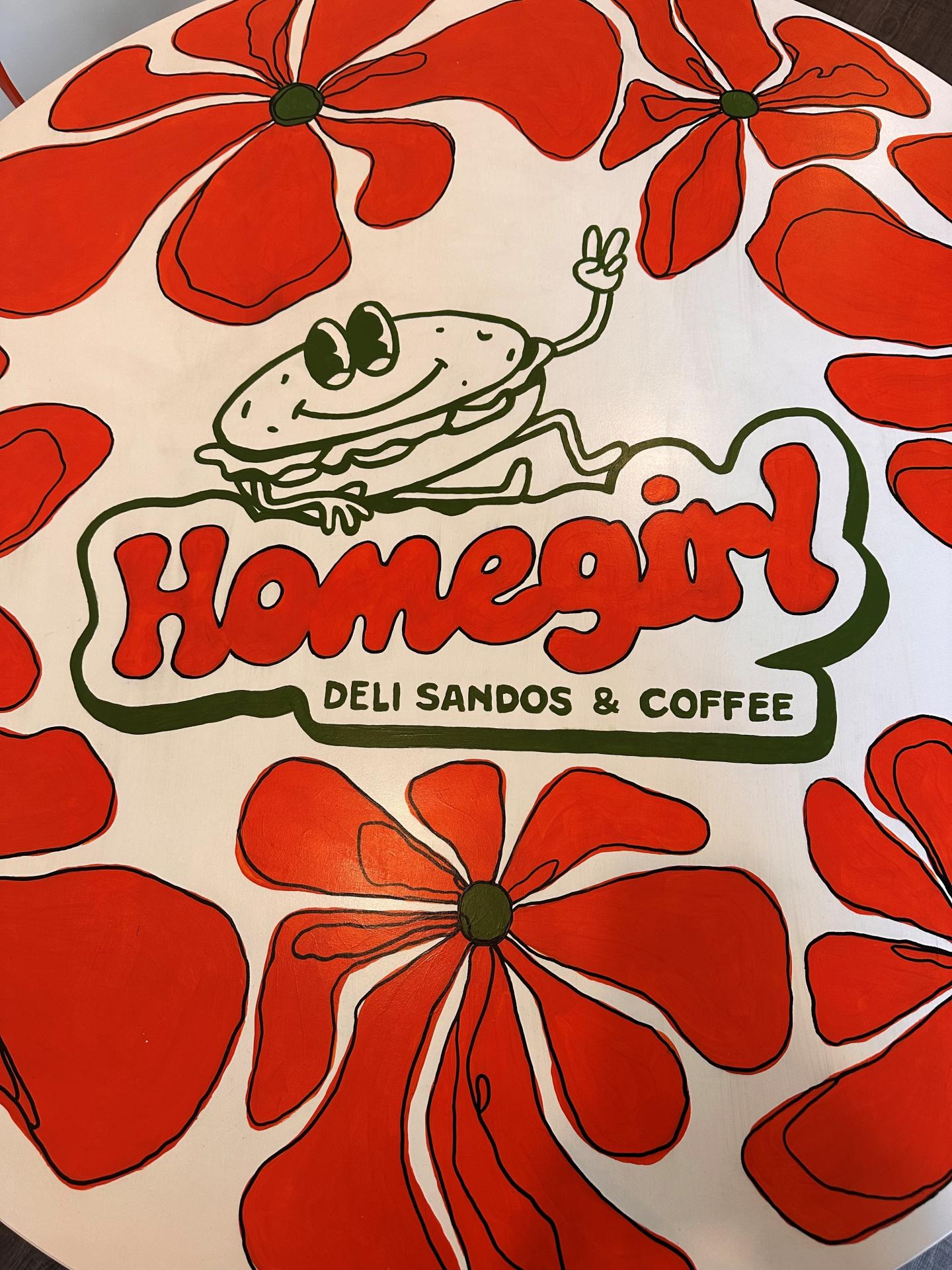 Cartoon sandwich with peace sign, red flowers, "Homegirl" text.