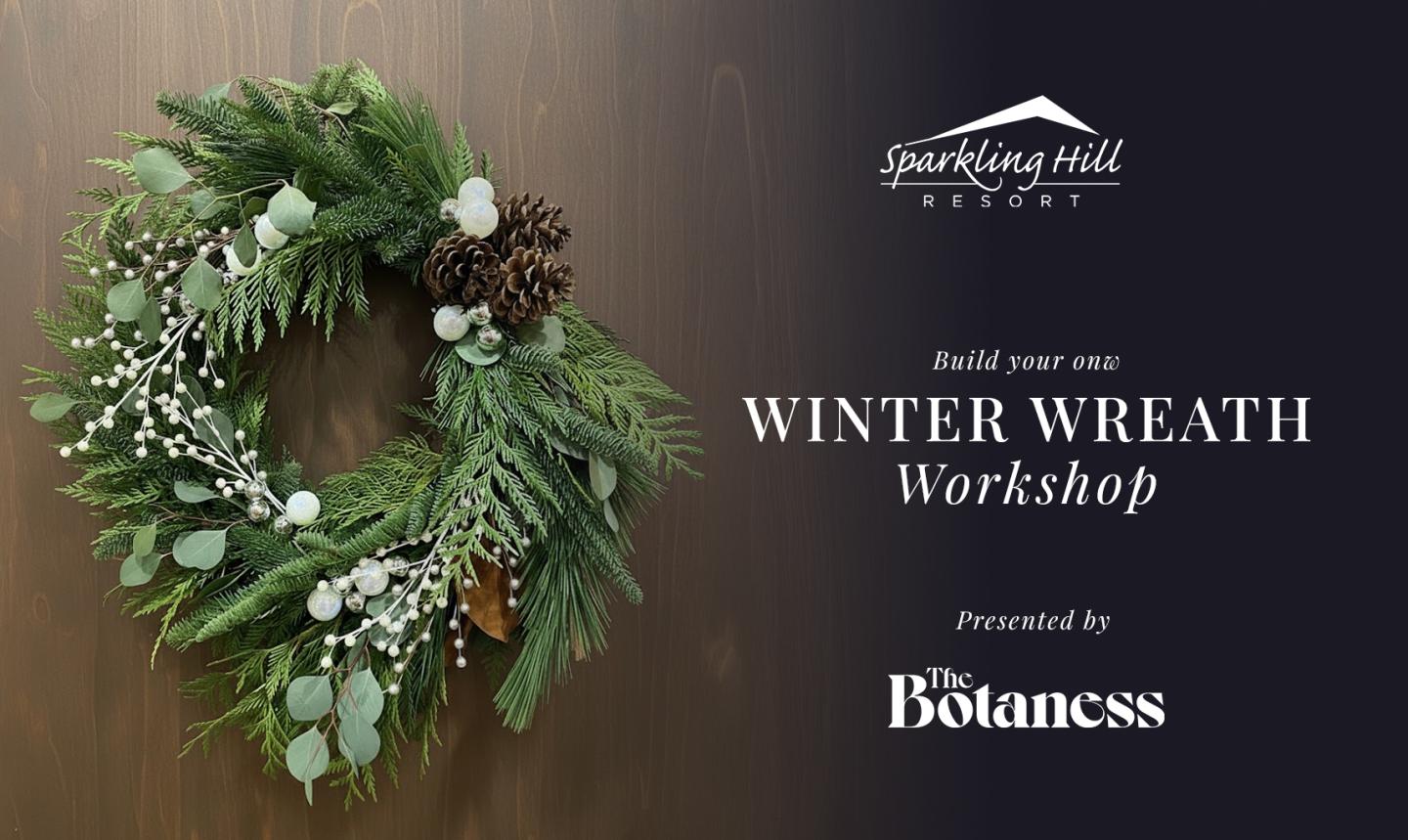 A festive winter wreath made of fresh evergreens, eucalyptus, pinecones, and white berries hanging on a wooden wall, beside text that reads ‘Build your own Winter Wreath Workshop presented by The Botaness at Sparkling Hill Resort.