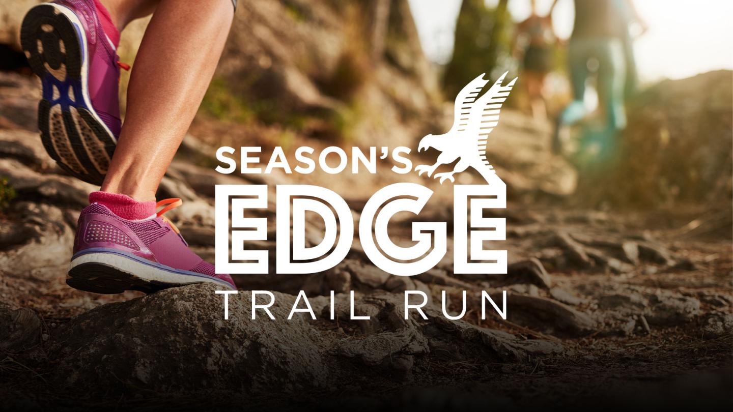 A person running on a trail at Predator Ridge.