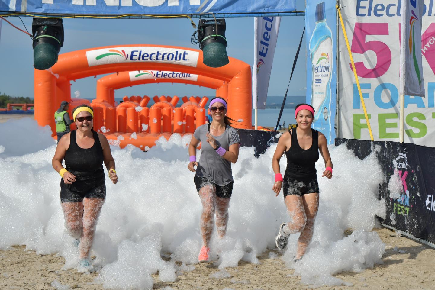 Image showing participants running through foam with a inflatable obstacle in the background