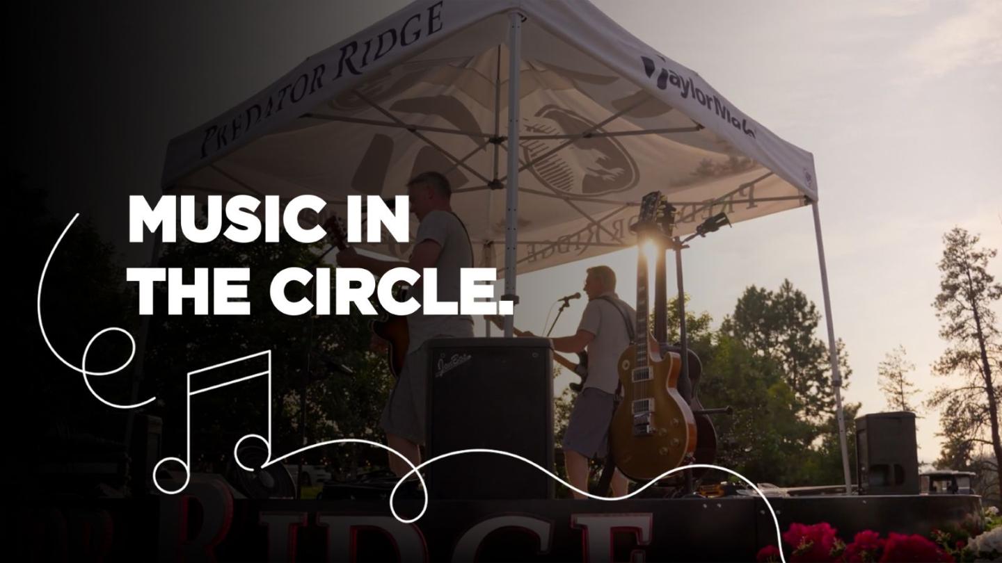 Band performing under a tent at an outdoor event.
