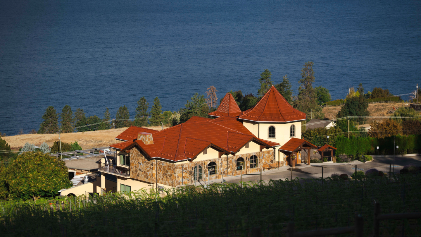 A fall photo of Gray Monk winery. The sun is shining and it's overlooking Okanagan Lake.